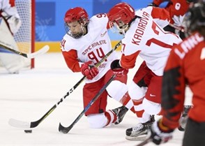 GANGNEUNG, SOUTH KOREA - FEBRUARY 11: Yevgenia Dyupina #94 of the Olympic Athletes of Russia plays the puck while Fanuza Kadirova #17 looks on during preliminary round action against Canada at the PyeongChang 2018 Olympic Winter Games. (Photo by Andre Ringuette/HHOF-IIHF Images)

