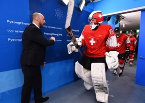 GANGNEUNG, SOUTH KOREA - FEBRUARY 15: Switzerland's Leonardo Genoni #63 fist bumps assistant coach Christian Wohlwend walking out to warmup during preliminary round action at the PyeongChang 2018 Olympic Winter Games. (Photo by Matt Zambonin/HHOF-IIHF Images)

