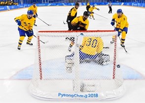 GANGNEUNG, SOUTH KOREA - FEBRUARY 21: Germany's Christian Ehrhoff #10 gets the puck past Sweden's Viktor Fasth #30 to score a first period goal with Mikael Wikstrand #5, Johan Fransson #8 and Germany's Matthias Plachta #22 and Felix Schutz #55 looking on during quarterfinal round action at the PyeongChang 2018 Olympic Winter Games. (Photo by Matt Zambonin/HHOF-IIHF Images)

